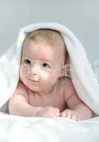 baby under white blanket