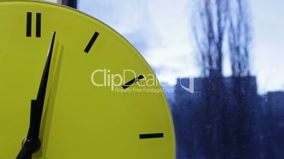 Yellow clock and the city. Time lapse.