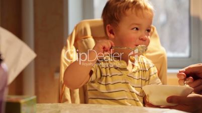 Little boy eats porridge.