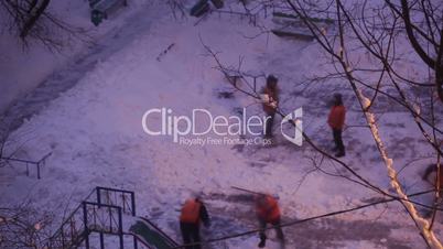 Street cleaners in orange uniform removing the snow. Time lapse.