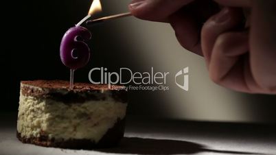 Candle six in tiramisu cake.