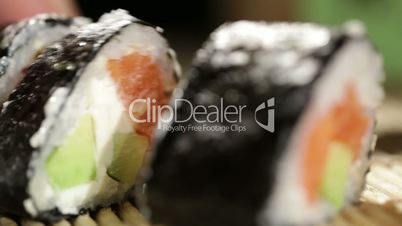 Cutting sushi rolls.