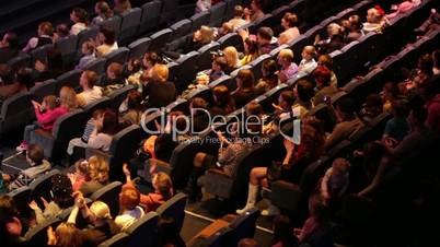 Anonymous people applaud at the theatre performance.