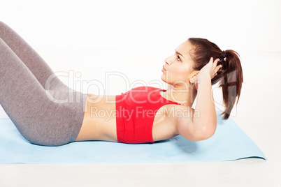 fit young woman practicing abdominal exercises