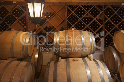 Wine Barrels and Bottles in Cellar