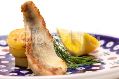 Appetizer of Perch Filet with Fried Potatoes, Lemon and Dill