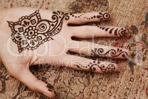 henna art on woman's hand