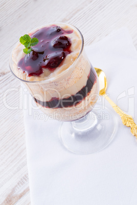 vanilla pudding with cherry and biscuit