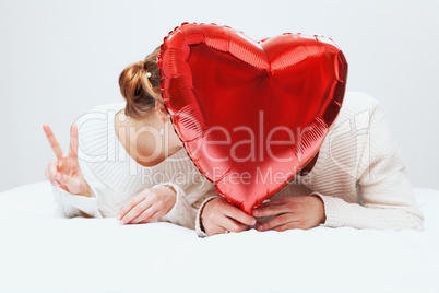 The girl and the guy with balloons in the form of heart