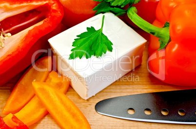 Feta cheese with a knife and vegetables