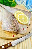 Fillets codfish on a board with a knife
