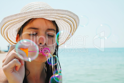 Teen girl blowing bubbles