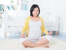 Asian pregnant woman meditating
