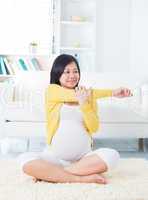 Pregnant woman yoga at home.
