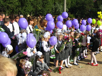 children with flowers and balloons on a holiday of the 1st september