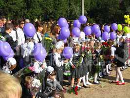 children with flowers and balloons on a holiday of the 1st september