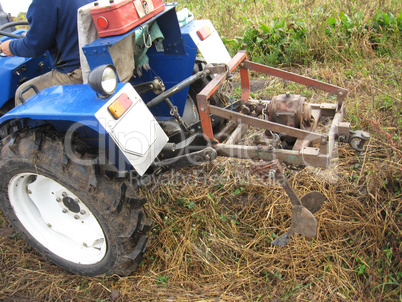 Tractor with a plough