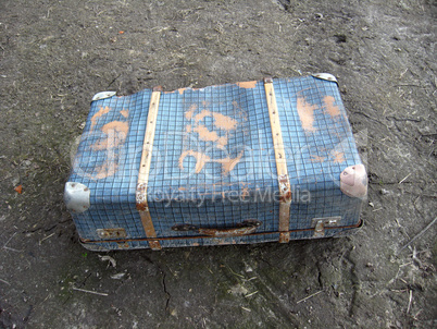 Old suitcase on the ground