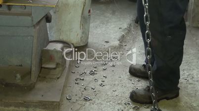 working at the plant presses his foot on the pedal machine