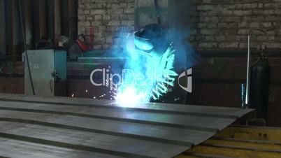 male welder working with metal at the plant