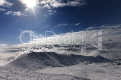 Off-piste slope in clouds