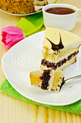 Cake with pink tulips on a wooden board