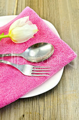 Fork and spoon with white tulips