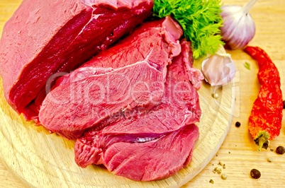 Meat beef on a wooden board with vegetables