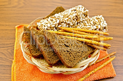 Rye bread and crispbreads in a wicker plate on napkin