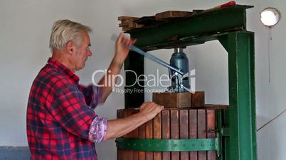 Farmer working with  the wine press