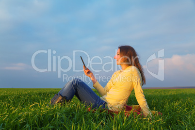 teen girl reading electronic book