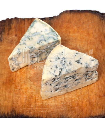 Dorblu cheeses on old wooden board