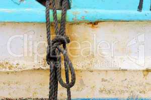 Peeling paint on rusted metal surface.