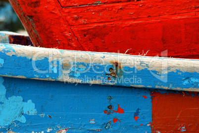 Peeling paint on rusted metal surface.