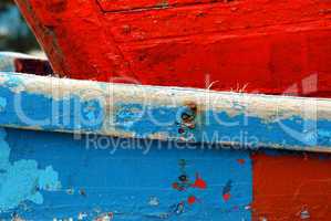 Peeling paint on rusted metal surface.