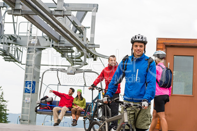 Couple getting on bicycles chair lift trip
