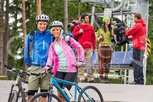 Mountain bikes couple and hikers after chair lift