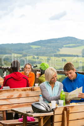 Young couple read map mountain bikers sport