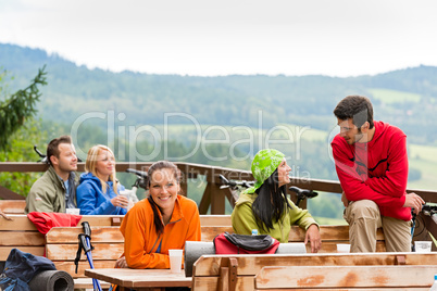 Talking friends enjoying mountain view rest place