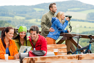 Friends hiking mountains read map look binoculars