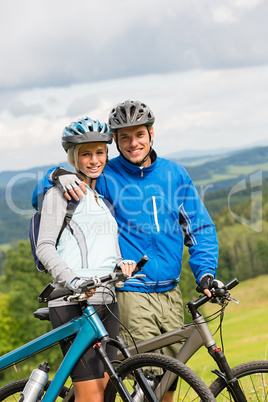 Sporty couple enjoying fresh air bicycles nature