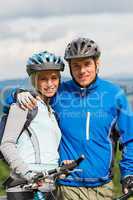 Young sporty couple with mountain bikes in helmet