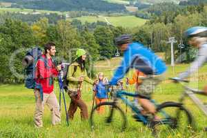 Tourists hiking and riding mountain bikes summer nature
