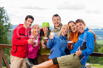 Posing smiling young people with beer outdoors