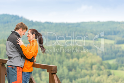 Smiling couple hugging outdoors nature background