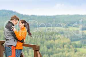 Smiling couple hugging outdoors nature background