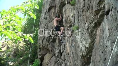 bare-chested guy with a rock climbing