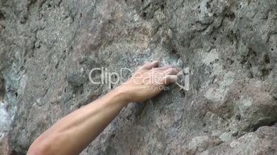 close-up of a hand climber who clings to the stone