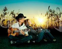 Love story. A young man playing guitar for his girl.