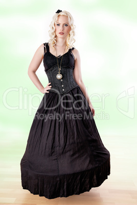 Woman with curly hair in long black dress